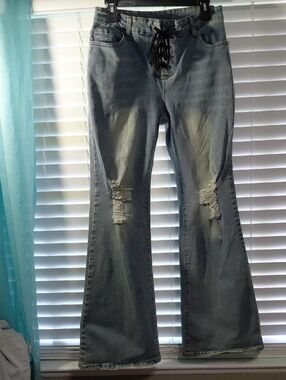 High-Rise Light Blue Distressed Flare Jeans with Lace-Up Waist. Size 31